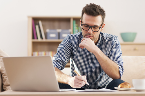 Photo of a man studying at a table